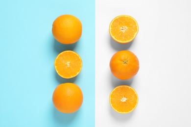 Flat lay composition with ripe oranges on color background