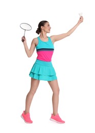 Young woman playing badminton with racket on white background