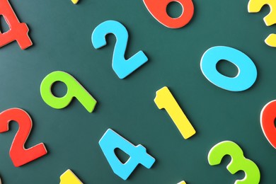 Photo of Colorful numbers on green background, flat lay