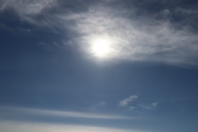 Photo of Bright sun and fluffy white clouds in blue sky