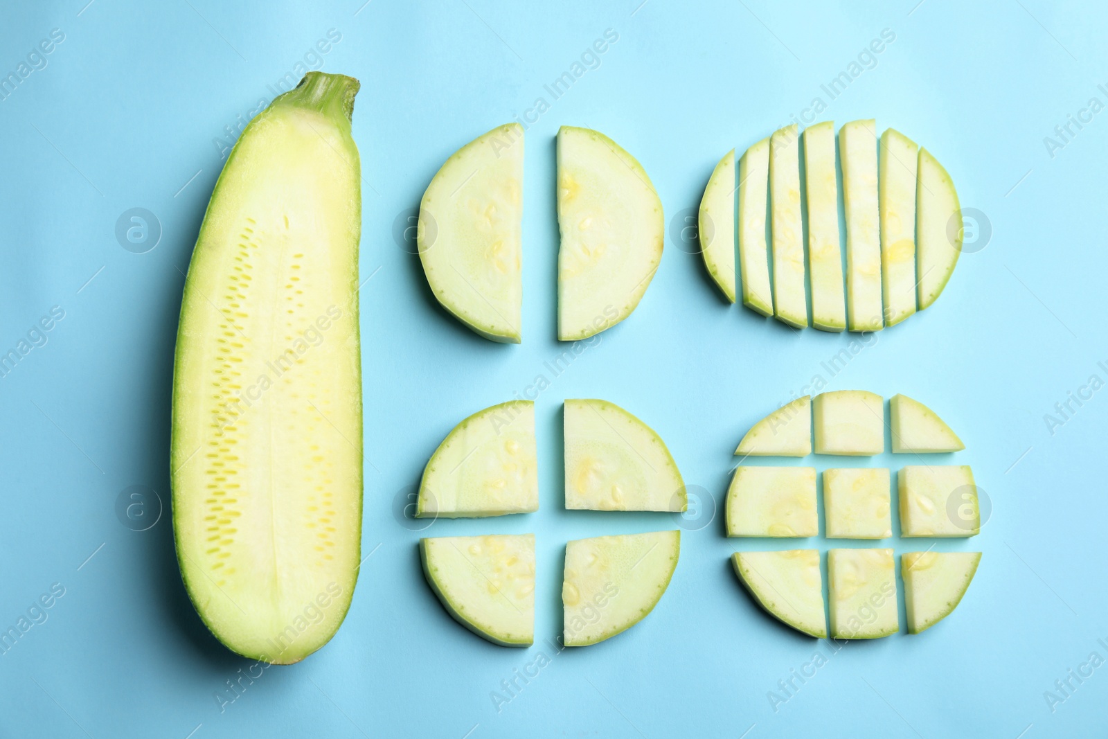 Photo of Fresh ripe green zucchini on light blue background, flat lay