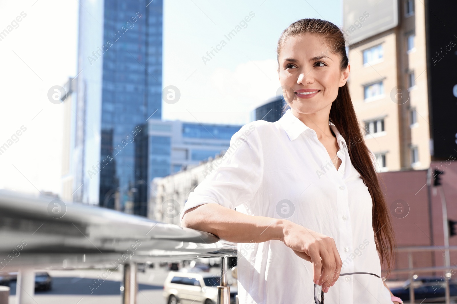 Photo of Beautiful businesswoman with glasses on city street