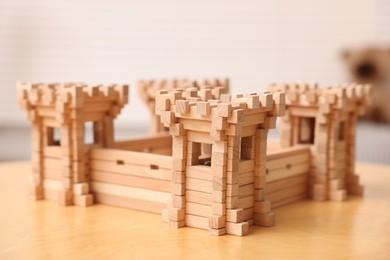 Photo of Wooden fortress on table indoors, closeup. Children's toy