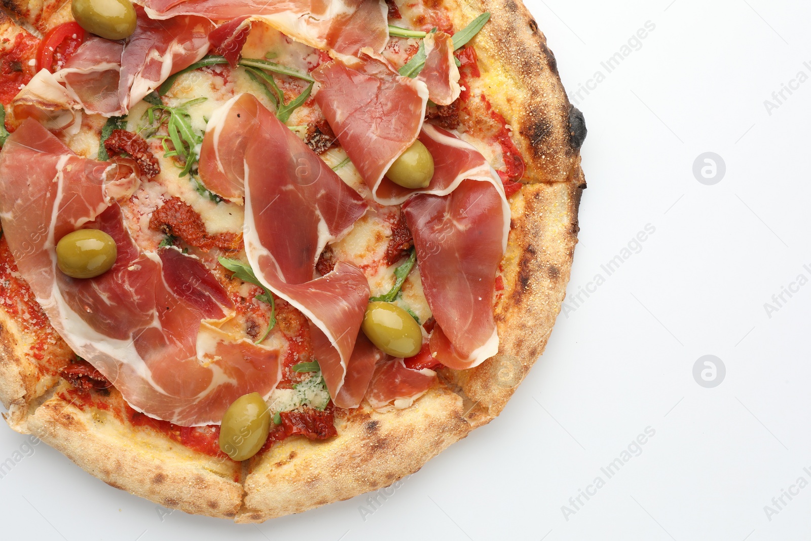 Photo of Tasty pizza with cured ham, olives and sun-dried tomato isolated on white, top view