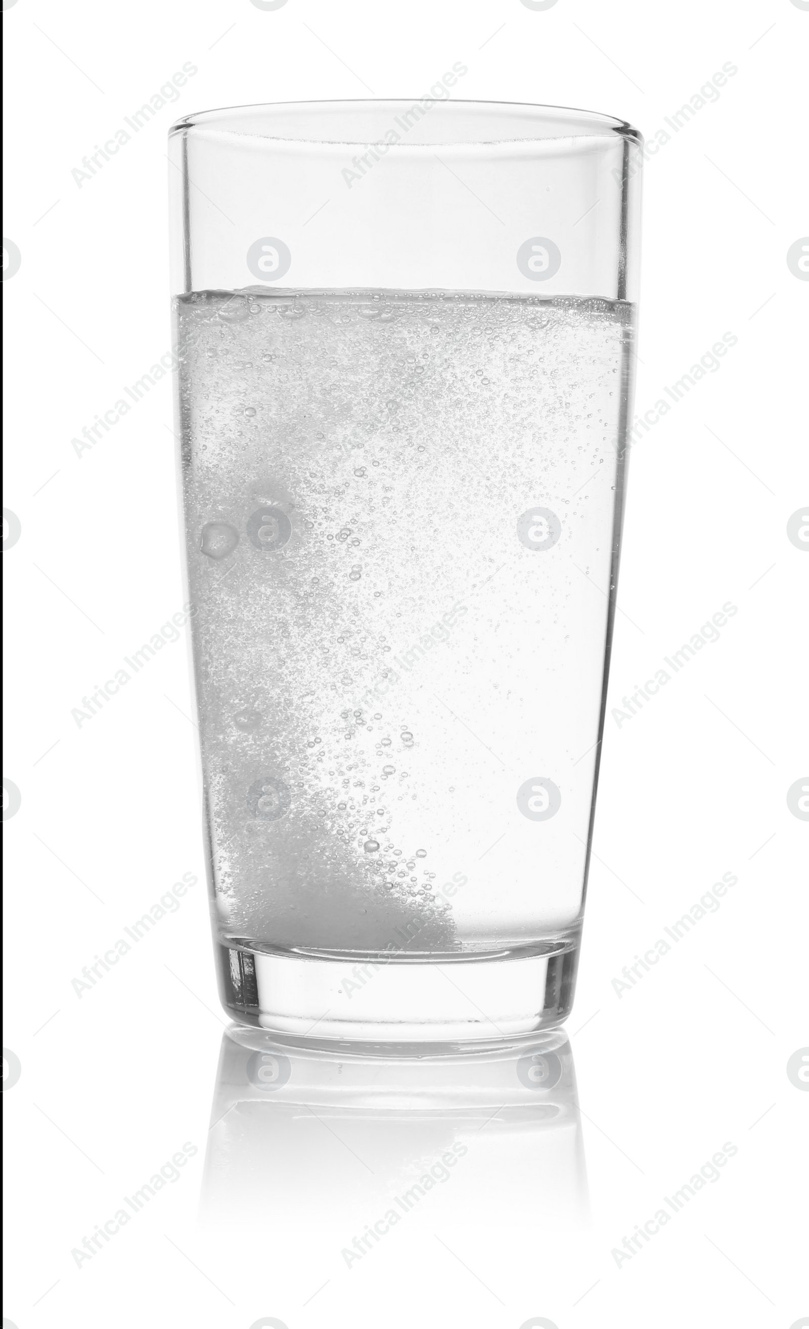 Photo of Effervescent pill dissolving in glass of water isolated on white