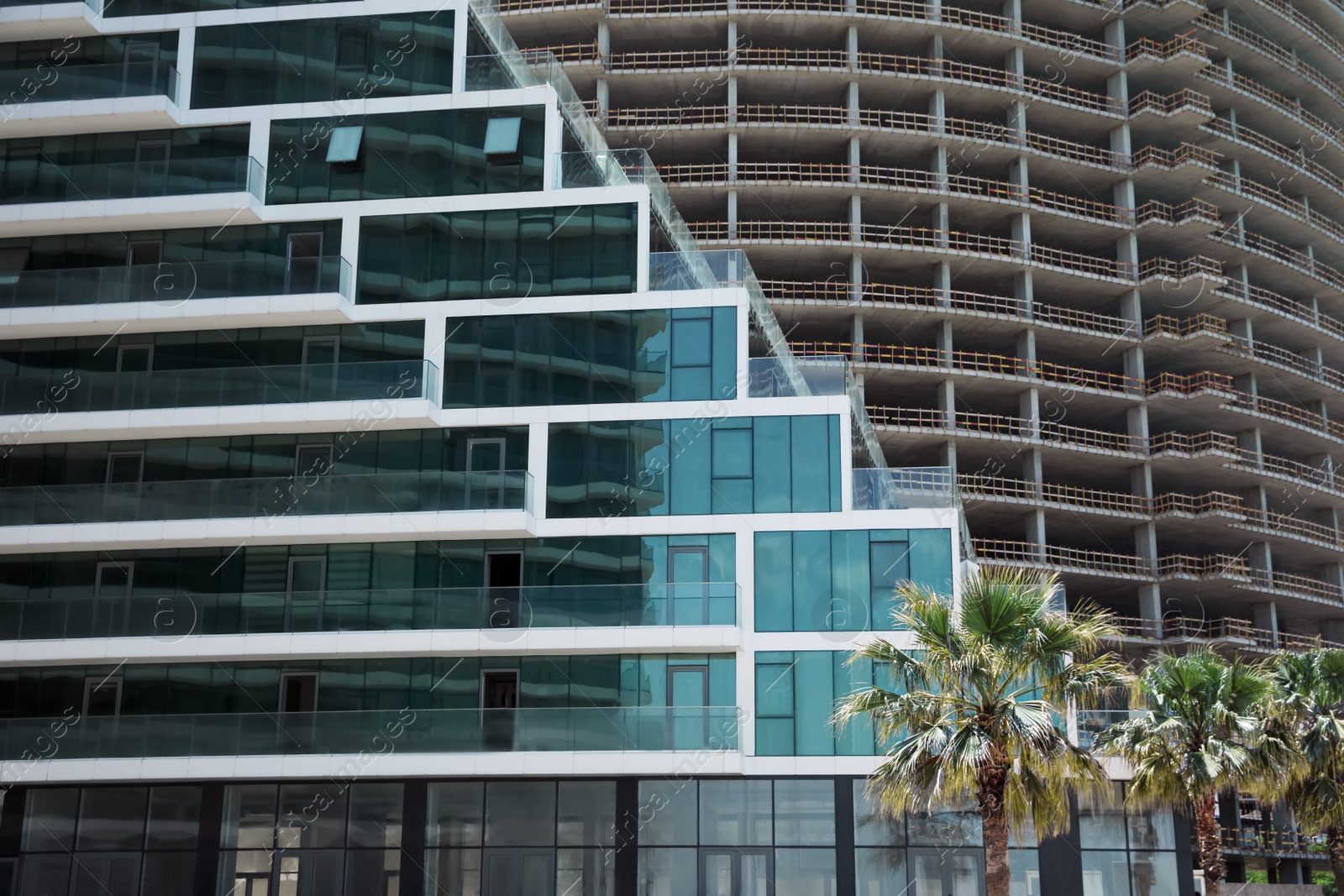 Photo of Modern and unfinished buildings outdoors. Construction site