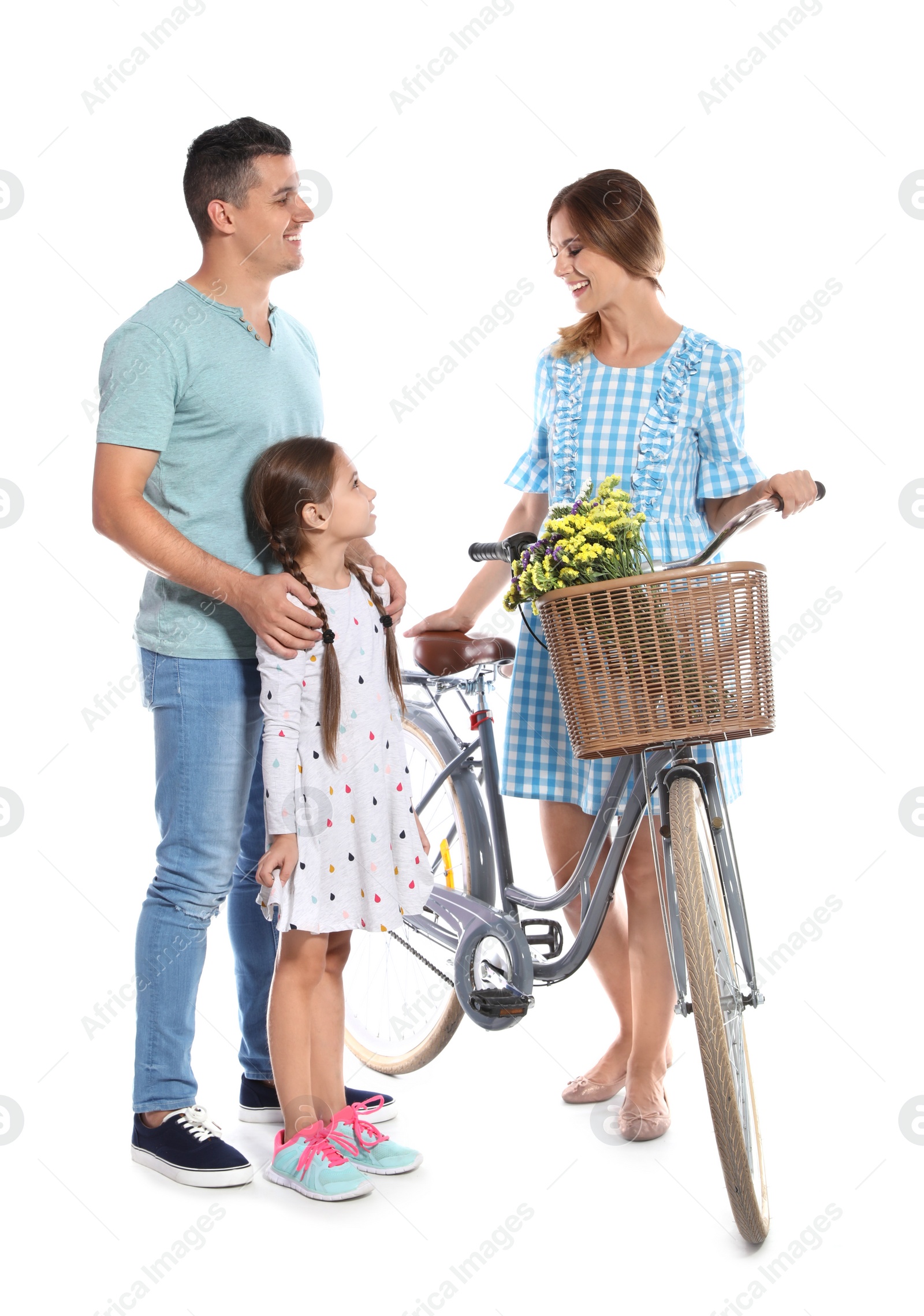 Photo of Portrait of parents and their daughter with bicycle on white background