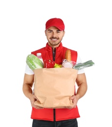 Photo of Young man holding paper bag with products on white background. Food delivery service