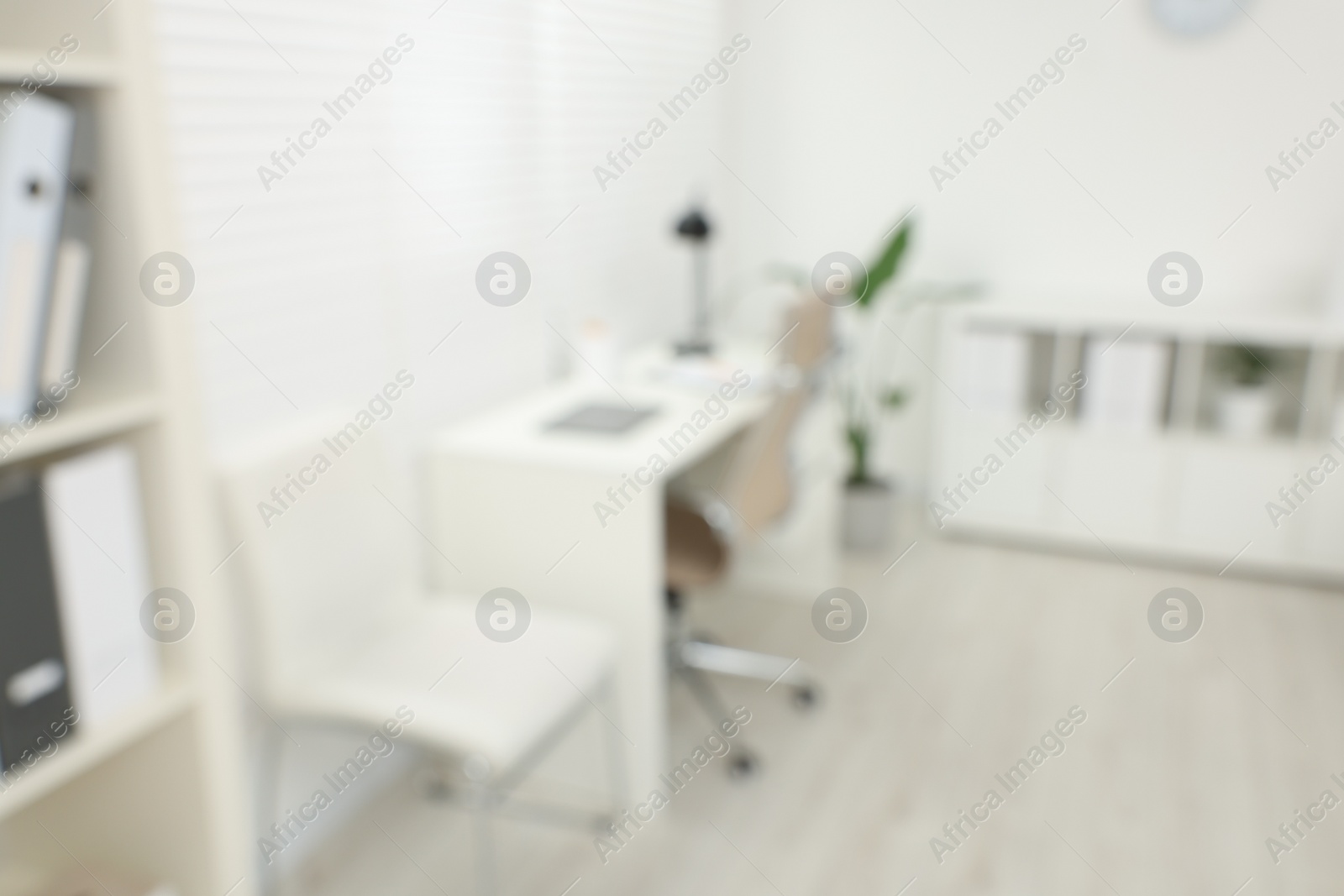 Photo of Blurred view of modern medical office with doctor's workplace in clinic