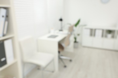 Photo of Blurred view of modern medical office with doctor's workplace in clinic