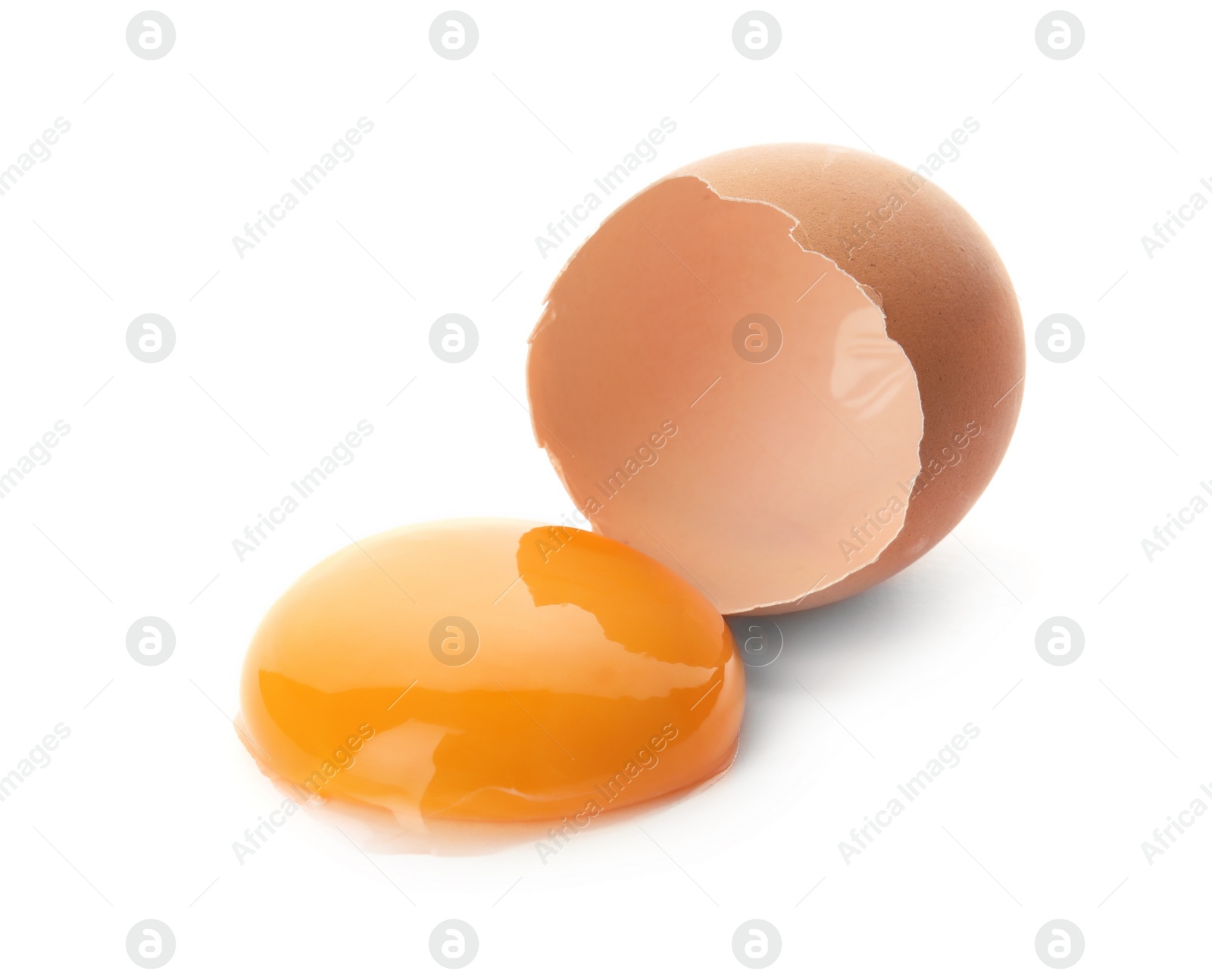 Photo of Egg yolk with cracked shell on white background