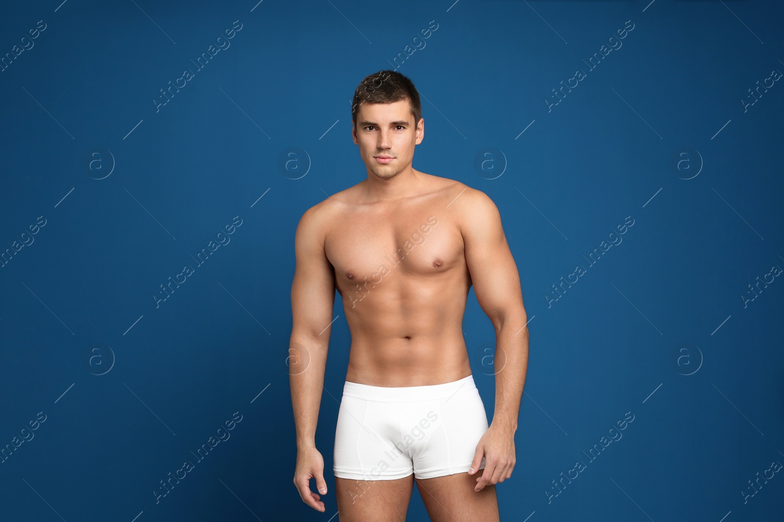 Photo of Man with sexy body on blue background