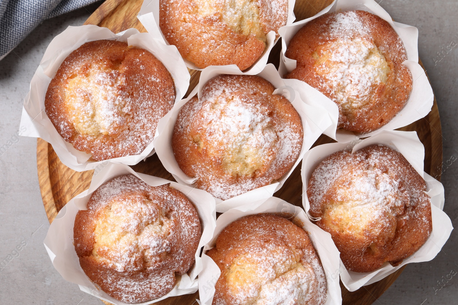 Photo of Delicious muffins on grey table, top view