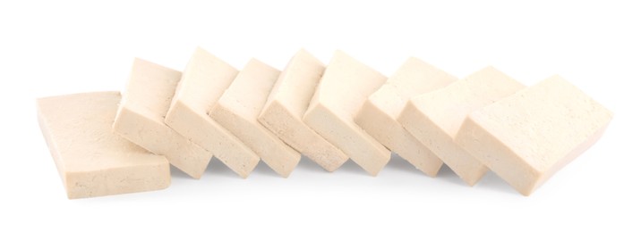 Photo of Slices of delicious raw tofu on white background