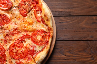 Hot cheese pizza Margherita on wooden table, top view. Space for text