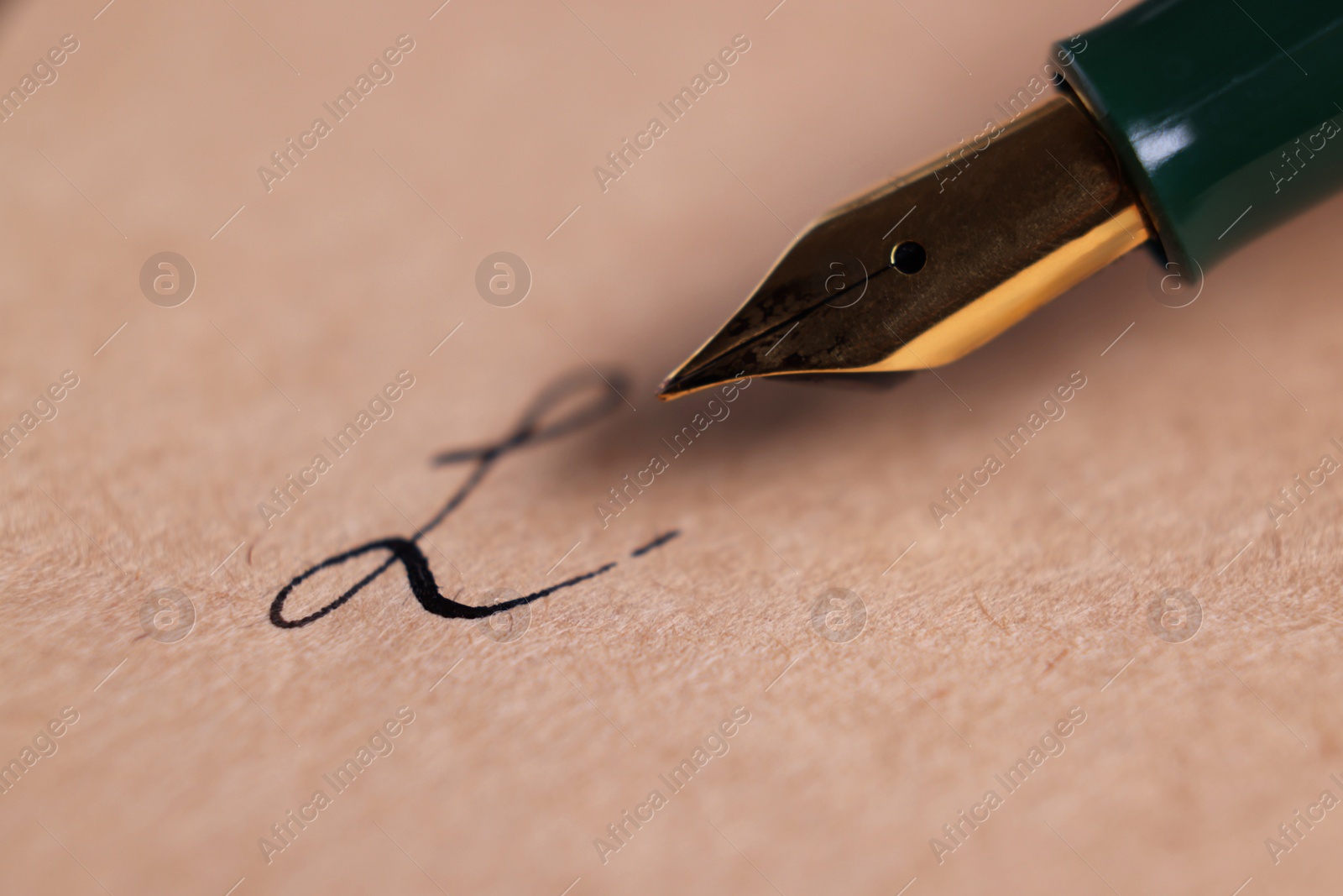 Photo of Fountain pen and signature on sheet of paper, closeup