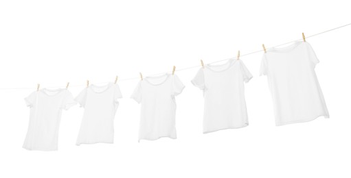 Many t-shirts drying on washing line isolated on white, low angle view