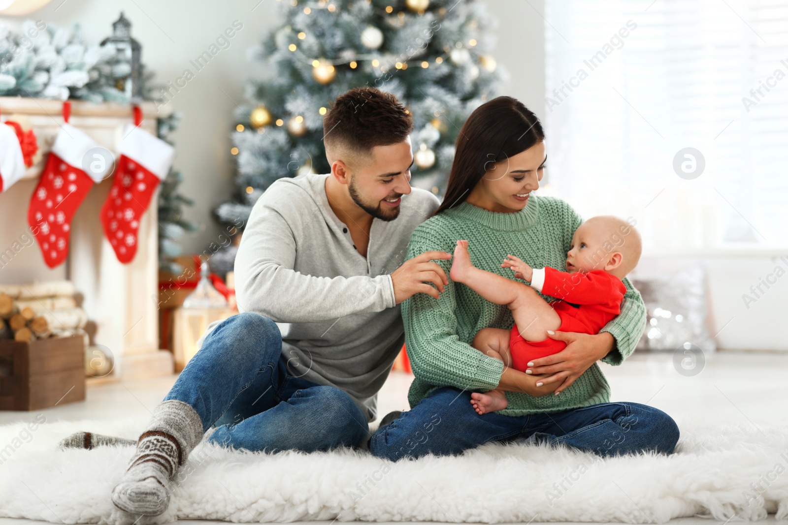 Photo of Happy family with cute baby at home. Christmas celebration