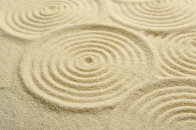 Photo of Zen rock garden. Circle patterns on beige sand
