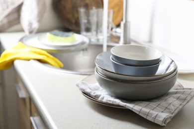 Photo of Clean bowls near kitchen sink. Washing dishes