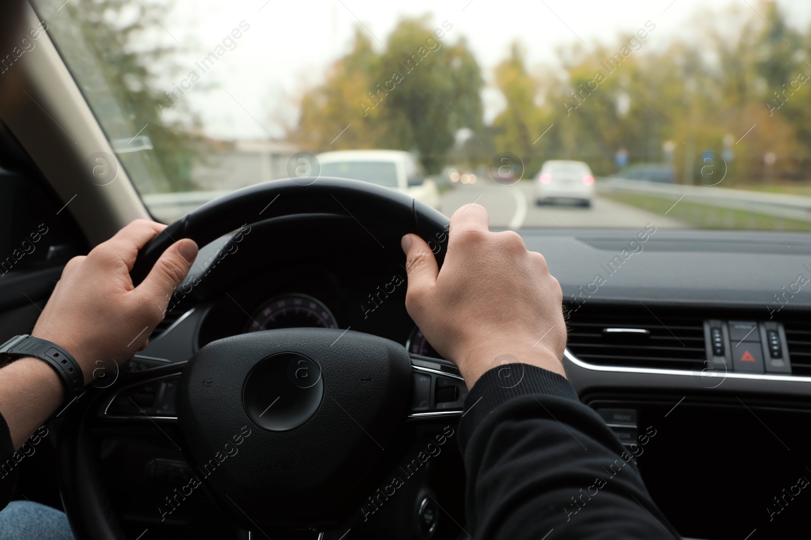 Photo of Man driving his car, closeup. Traffic rules