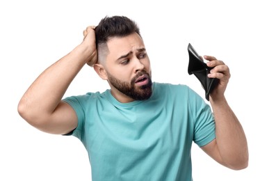 Photo of Upset man showing empty wallet on white background