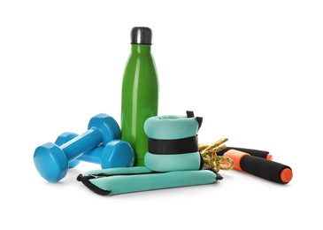 Photo of Stylish weighting agents and sport equipment on white background