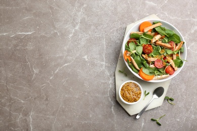 Photo of Delicious fresh chicken salad served on grey table, top view. Space for text