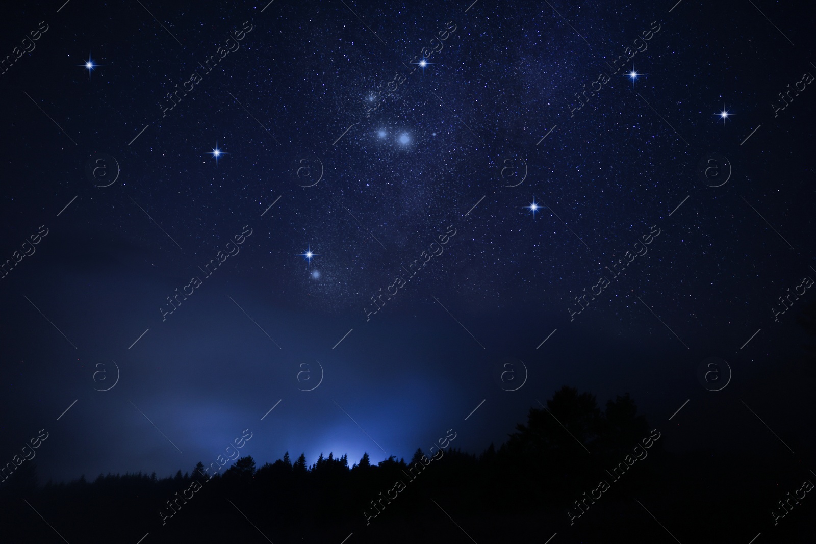 Image of Beautiful starry sky over dark misty forest at night