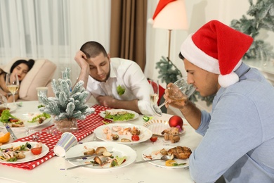 People suffering from hangover at table after New Year party
