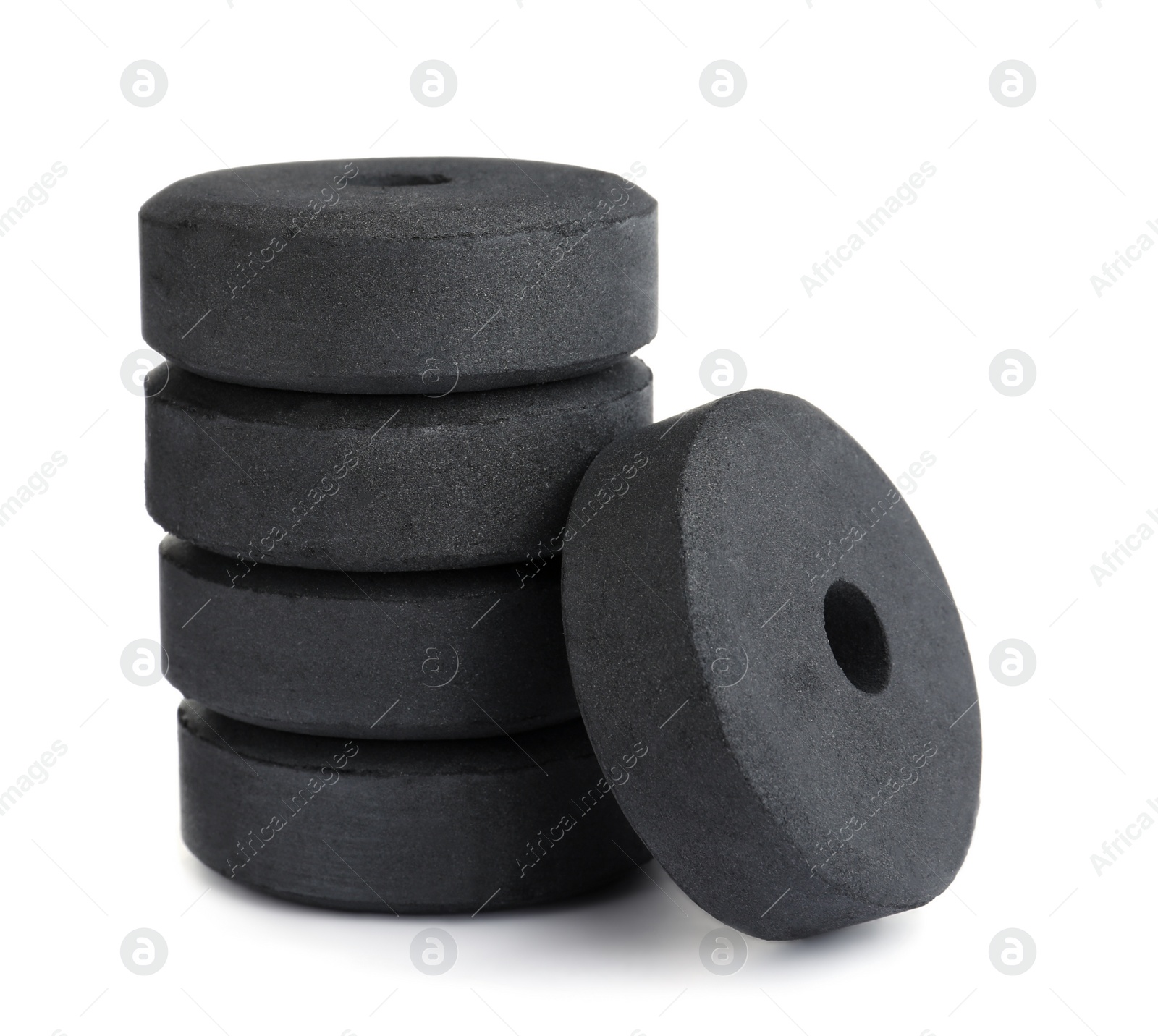 Photo of Stack of charcoal rings for hookah on white background