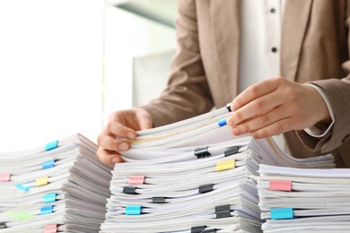 Photo of Woman working with documents in office, closeup