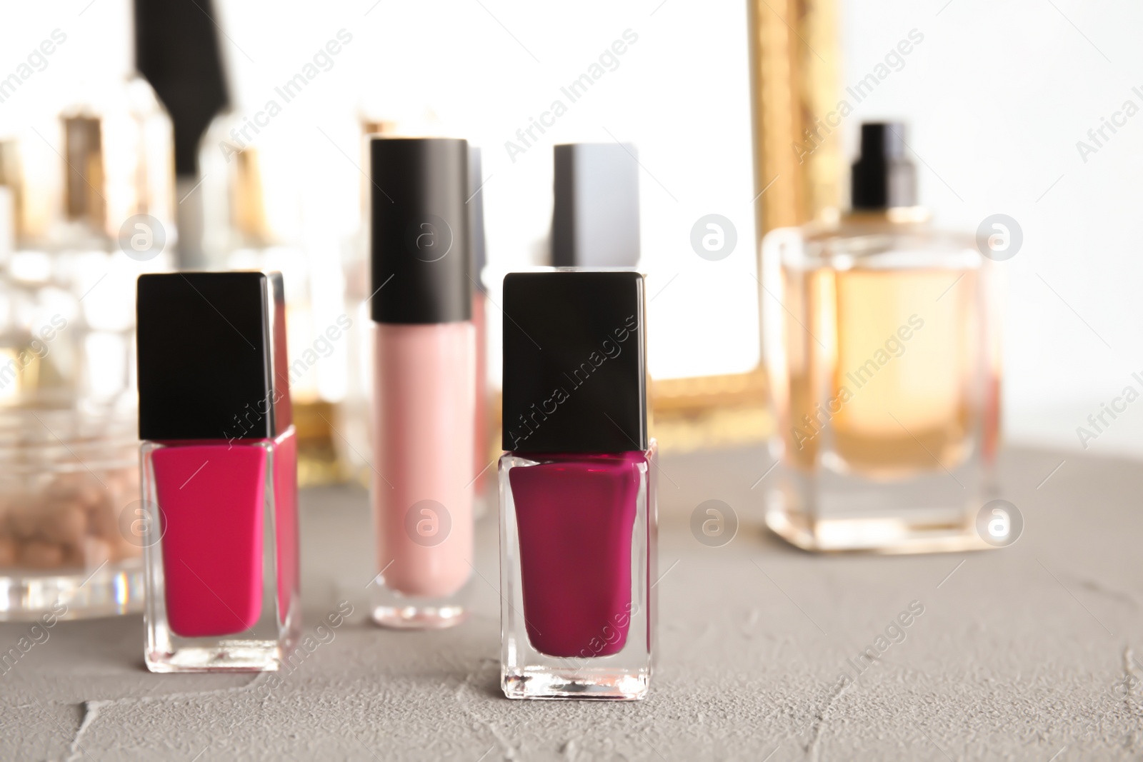 Photo of Bottles of nail polish on dressing table. Space for text