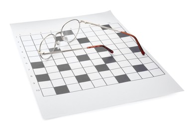 Photo of Blank crossword and eyeglasses on white background