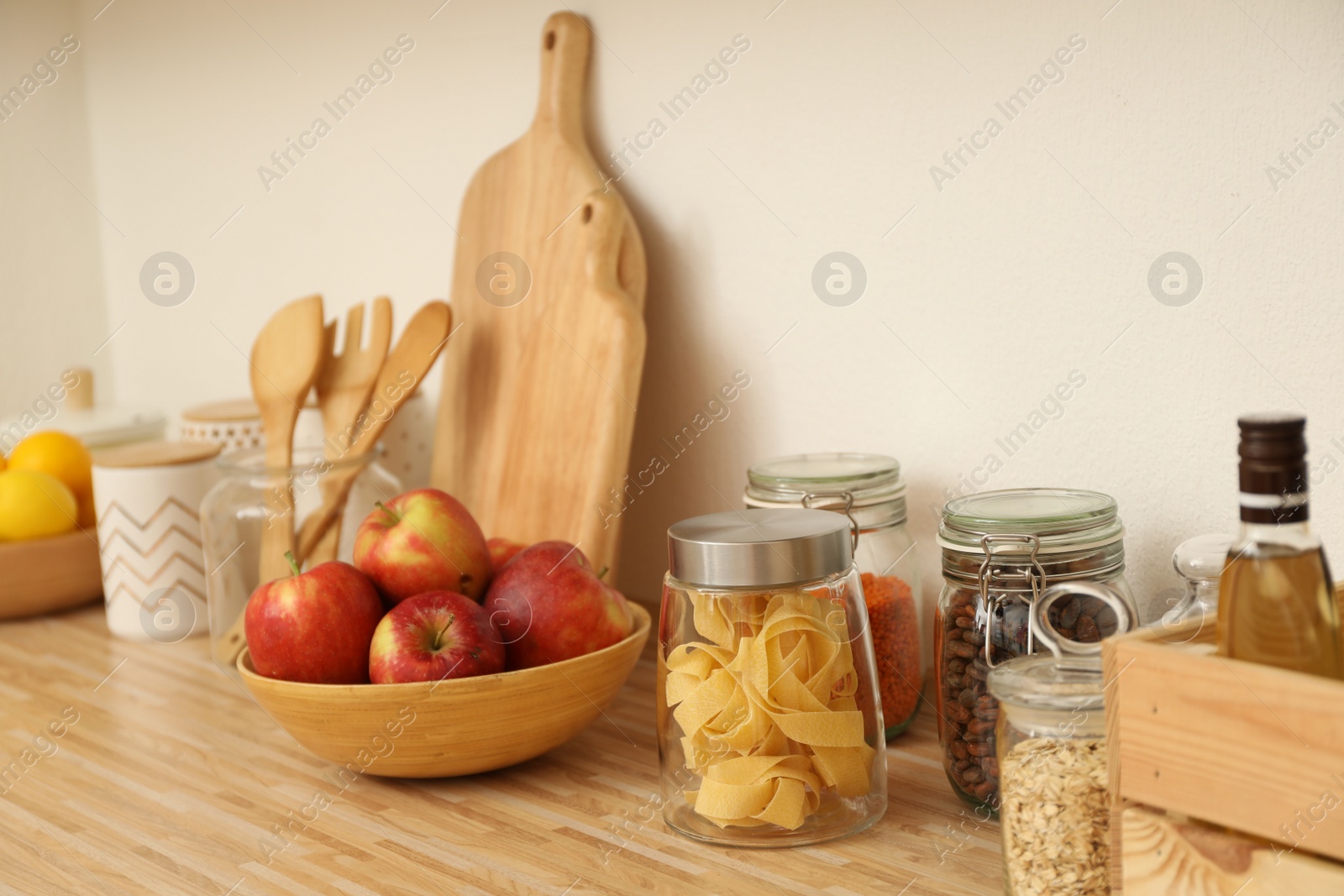 Photo of Different products on wooden countertop in kitchen