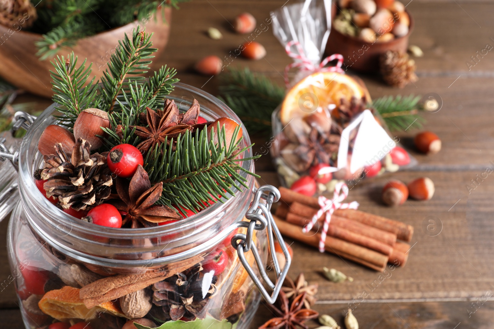 Photo of Aroma potpourri with different spices on wooden table, space for text