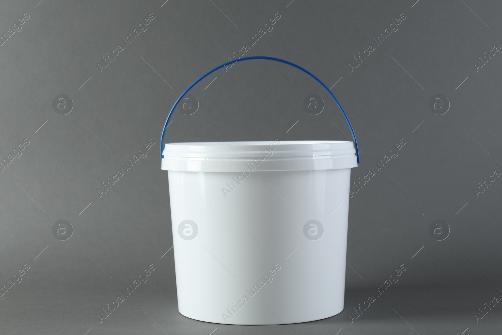 Photo of One plastic bucket with lid on grey background