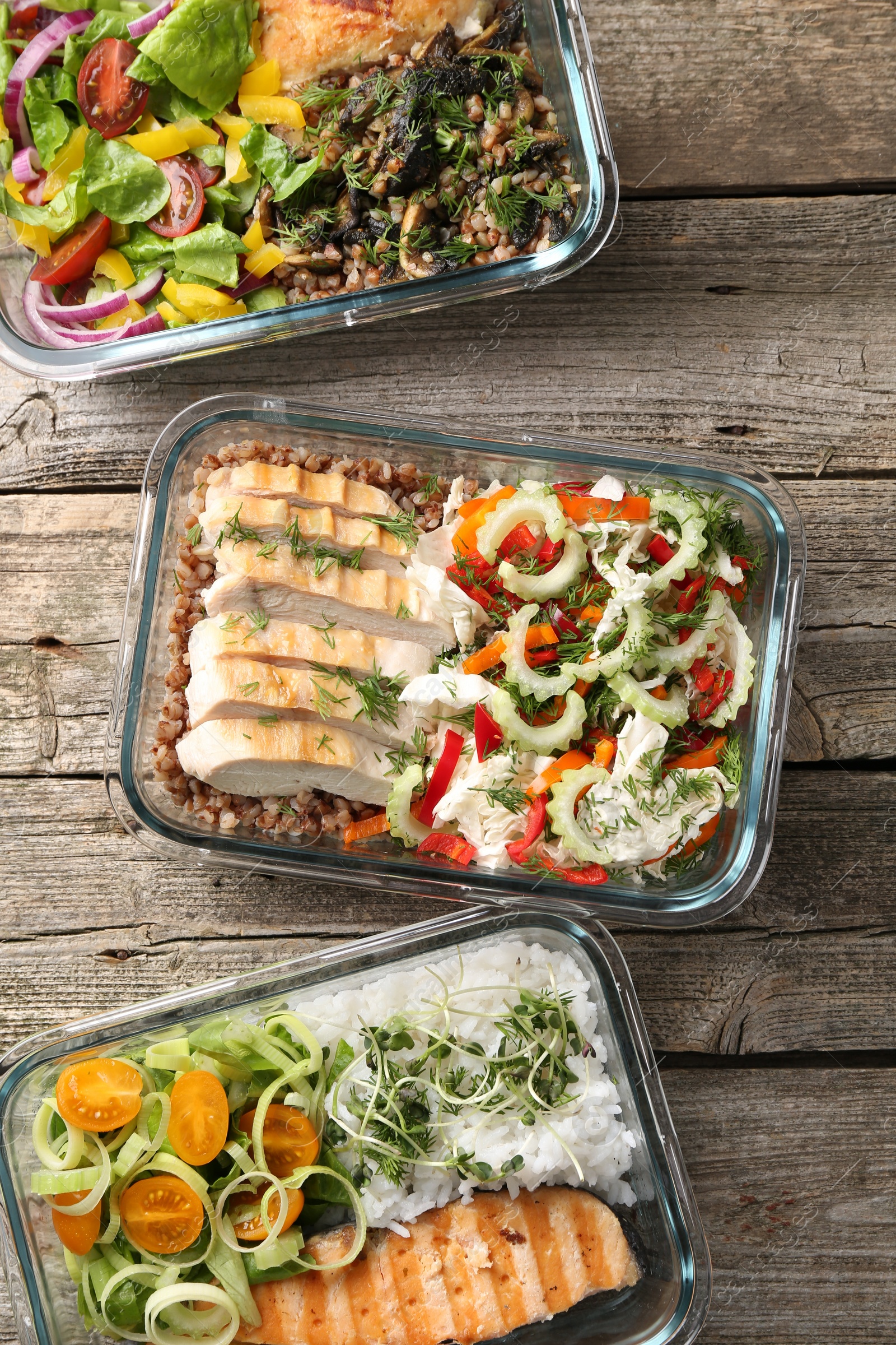 Photo of Healthy meal. Containers with different products on wooden table, flat lay