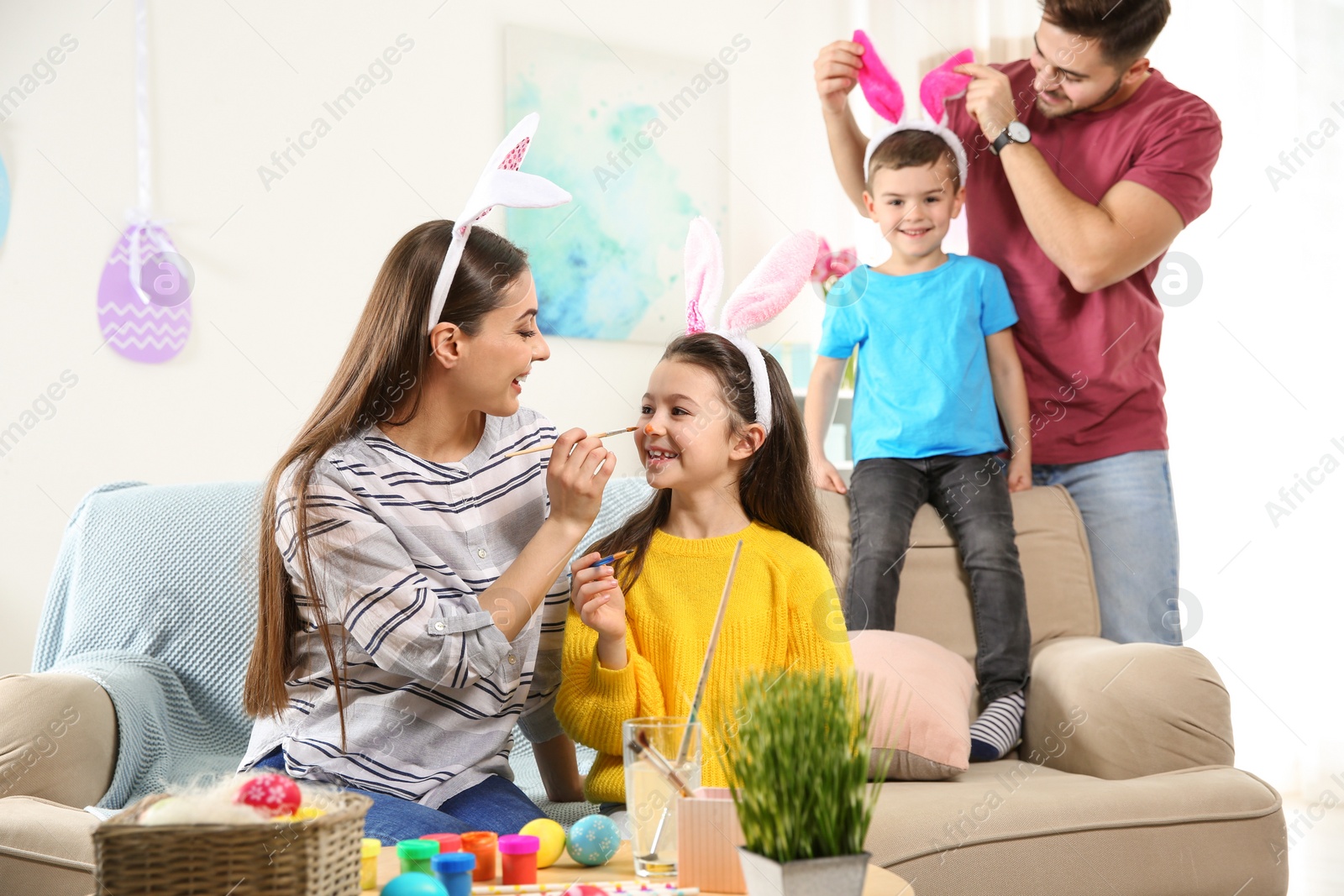 Photo of Happy family preparing for Easter holiday at home