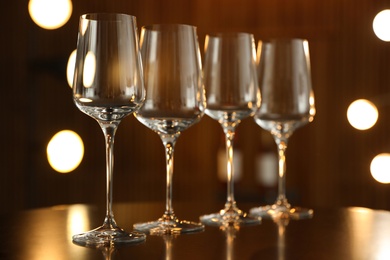Empty wine glasses on table against blurred background