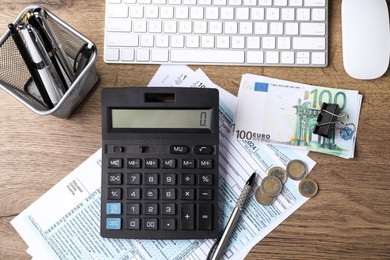 Photo of Tax accounting. Flat lay composition with calculator and documents on wooden table