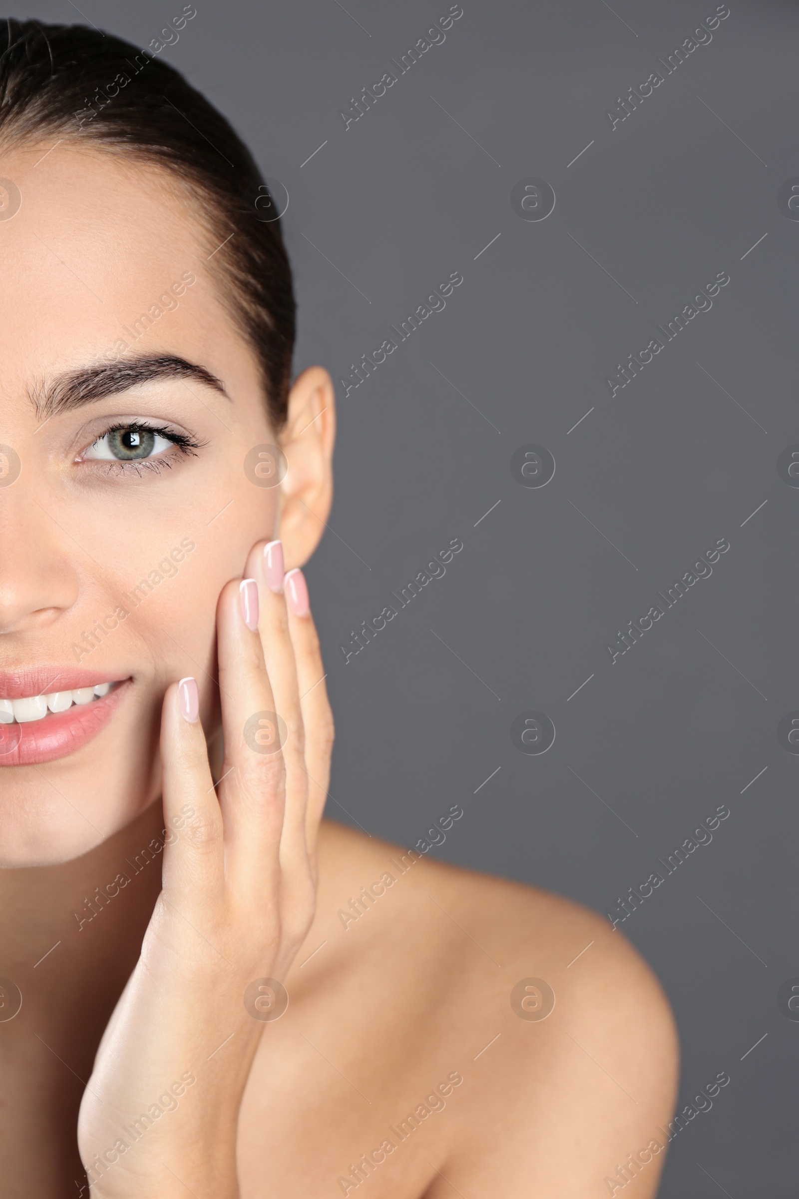 Photo of Portrait of beautiful young woman and space for text on grey background. Cosmetic surgery concept