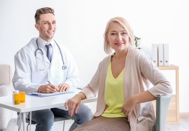 Photo of Male doctor consulting patient in clinic