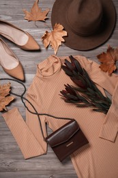 Photo of Fall fashion. Layout of women's outfit on wooden background, top view