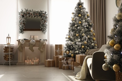 Stylish Christmas interior with beautiful decorated tree and fireplace