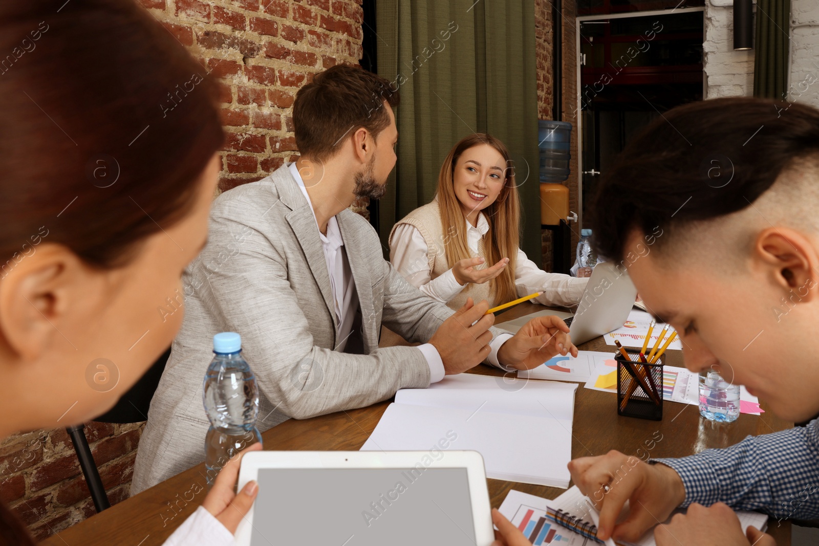 Photo of Team of employees working together in office