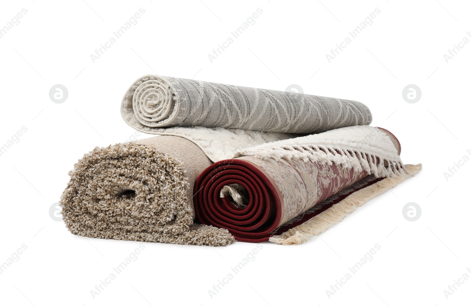 Photo of Rolled carpets on white background. Interior element