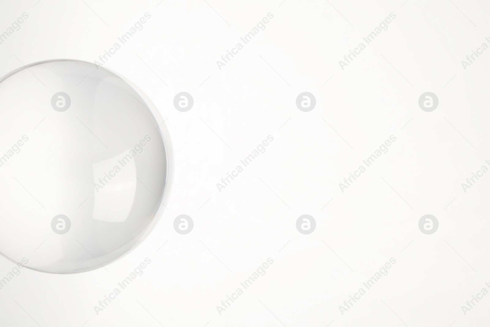 Photo of Transparent glass ball on white background. Space for text