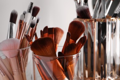 Photo of Set of professional brushes on light background, closeup