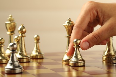 Photo of Woman moving chess piece on board, closeup